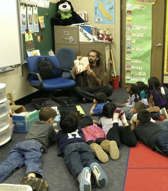 Reading to a classroom of kids